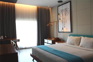 Posteľ alebo postele v izbe v ubytovaní Hotel Dafam Wonosobo