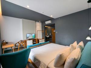 Posteľ alebo postele v izbe v ubytovaní Hotel Dafam Wonosobo