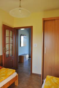 a bedroom with two beds and a hallway with a door at Domki U Tarnawy in Polanica-Zdrój
