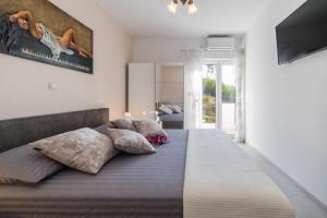ein Schlafzimmer mit einem großen Bett und Kissen in der Unterkunft Apartment Tafra 2 in Lokva Rogoznica