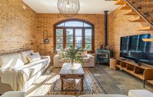 a living room with a brick wall at Beautiful Home In Conil De La Frontera in Conil de la Frontera