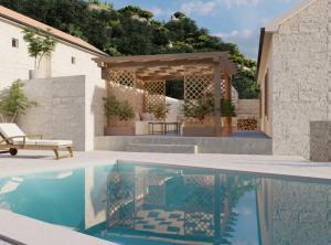 a swimming pool in front of a house at Villa Marina in Metković
