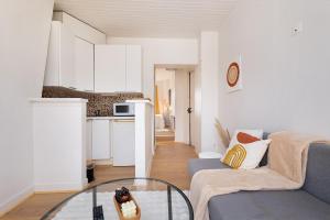 a living room with a couch and a glass table at Cosy and Central Sacré-Coeur View Appartment, 50m to Paris in Clichy