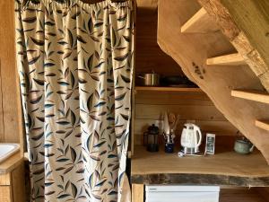 a bathroom with a shower curtain in a cabin at Cabane insolite Les Vargottes in Le Val-dʼAjol