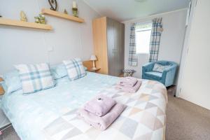 a bedroom with a bed with towels on it at Springfield B6 in Brixham