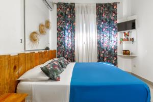 Postel nebo postele na pokoji v ubytování Hostal Mamà Mambò - Zona Colonial