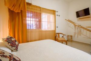Postel nebo postele na pokoji v ubytování Hostal Mamà Mambò - Zona Colonial