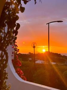 a sunset over a road with a basketball hoop at Apartamento Neptuno in Benagil