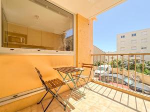 a balcony with a table and two chairs on it at Farges - Gare Saint Roch avec terrasse et garage privatif in Montpellier
