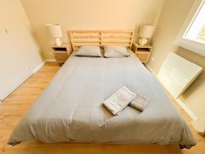 a large bed with two pillows on it in a bedroom at Farges - Gare Saint Roch avec terrasse et garage privatif in Montpellier +5 photos