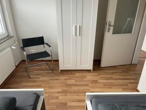 a room with a chair and a door and a chair at Fewo-H41 in Korschenbroich +23 photos