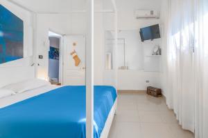 Postel nebo postele na pokoji v ubytování Hostal Mamà Mambò - Zona Colonial