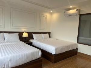 Postel nebo postele na pokoji v ubytování Sapa Warm Hotel