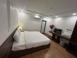 Postel nebo postele na pokoji v ubytování Sapa Warm Hotel