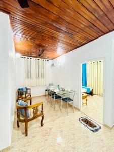 a living room with a table and a couch at Ranga's House in Weligama
