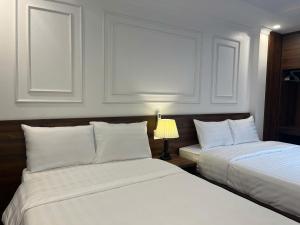 Postel nebo postele na pokoji v ubytování Sapa Warm Hotel