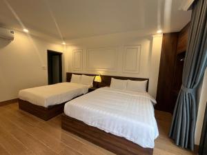 Postel nebo postele na pokoji v ubytování Sapa Warm Hotel