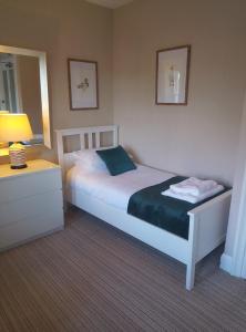 a bedroom with a bed and a lamp and a mirror at Barrasford Arms in Hexham