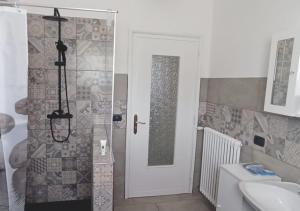a bathroom with a toilet and a sink and a door at Appartamento ZOIA in Crevacuore