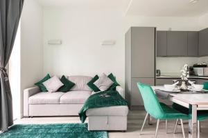 a living room with a couch and a table at Linford Serene in Milton Keynes