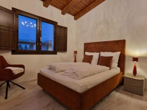 a bedroom with a bed with a chair and a window at Casa Toni, Villasimius in Villasimius +64 photos
