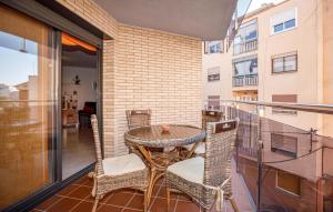 a patio with a table and chairs on a balcony at Beautiful Apartment In Pineda De Mar in Pineda de Mar