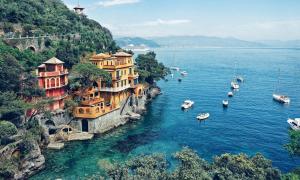 a group of boats in a body of water with buildings at Free parking Terrazza Mare - Portofino - Aria Condizionata in Rapallo