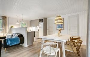 a kitchen and living room with a table and chairs at Holiday Home Kirstinevej Hvide Sande V in Bjerregård