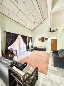 a large living room with couches and a couch at Teratai Homestay Batu Buruk in Kuala Terengganu