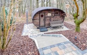 a wooden cabin with a bench in the woods at Ferienhaus 1 In Kirchheim in Kirchheim
