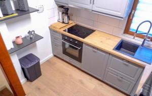 a small kitchen with a stove and a sink at Ferienhaus 1 In Kirchheim in Kirchheim +15 photos