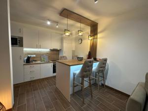 a kitchen with a counter and two bar stools at Apartman Vasić in Vrnjačka Banja