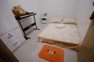 a bedroom with a bed and a shelf with stuffed animals at SMDC VINE Residence Rilakkuma-theme 2BR w Balcony in Manila +35 photos