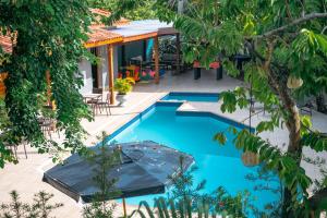 a swimming pool in the middle of a yard with trees at Ayla Praia Hotel Centro Porto Segur in Porto Seguro