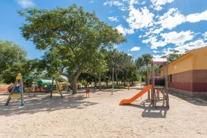an empty playground with a tree and a slide at Toledo ciudad de las tres culturas , un lugar para disfrutar todas las familias con sus hijos " DESAYUNO INCLUIDO" in Villamiel de Toledo