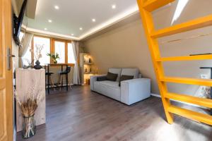 a living room with a loft bed and a couch at Paplanka Boutique Cabin in Nyírbátor