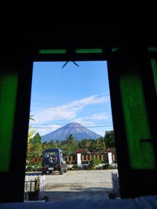 a view of a mountain through a window at Indah Damai Cottages in Sidomukti