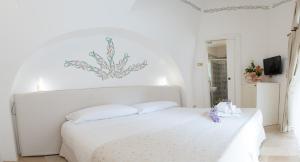 Uma cama ou camas num quarto em Dimora Dell'Osanna