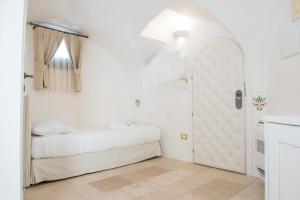 Uma cama ou camas num quarto em Dimora Dell'Osanna