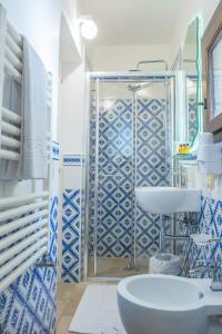 a blue and white bathroom with a sink and a tub at Dimora Dell'Osanna in Carovigno +37 photos