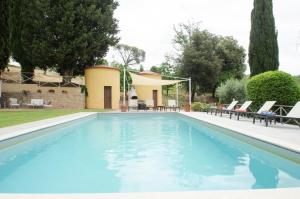 una piscina con sedie e una casa di Casa Febea a Chiusi