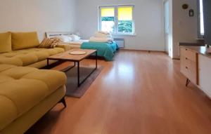 a living room with a couch and a table at Nice Apartment In Pobierowo With Wifi in Pobierowo
