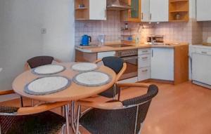 a kitchen with a table and chairs in a kitchen at Nice Apartment In Pobierowo With Wifi in Pobierowo
