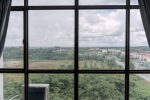 a view of a city from a window at SUMMER SUITES APARTMENT CASETTA HOMESTAY 1 at Kota Samaraham Kuching in Kota Samarahan