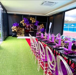 a long table with purple and white tables and chairs at Ndalo Lodge Mbombela in Nelspruit +64 photos