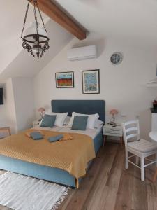 a bedroom with a bed and a table and a chair at Apartment Mamut in Premantura