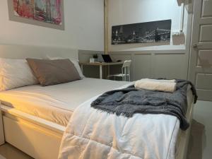 a bedroom with a bed with a blanket on it at The Elegant Bangna Suvarnabhumi in Ban Map Prasoe