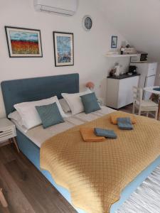 a bedroom with a large bed with two pillows on it at Apartment Mamut in Premantura