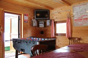 a ping pong table in the corner of a room at Apartments Kovačič in Bohinj