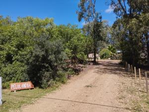 a dirt road with a sign that reads pullamine at Fusión Natural in Playa Verde